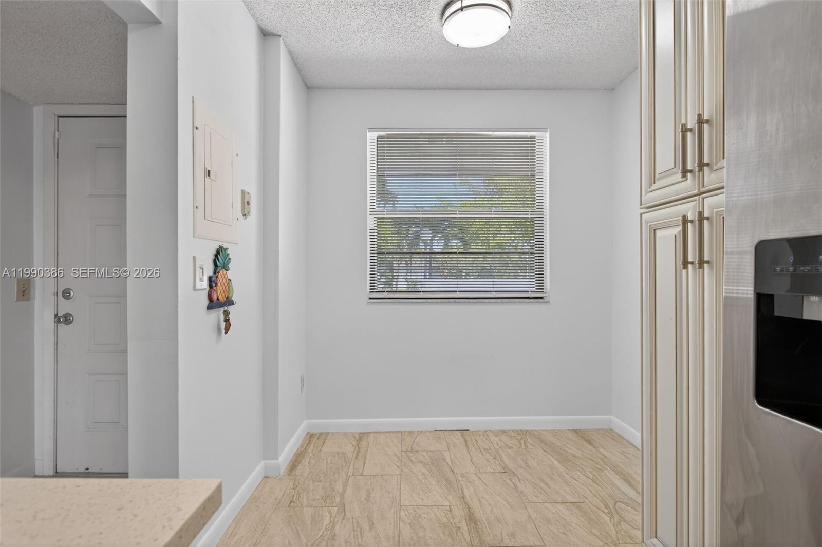 9670 West McNab Road, Unit 208 Tamarac, FL 33321 - Photo 11 of 47 a view of hallway with wooden floor and cabinet