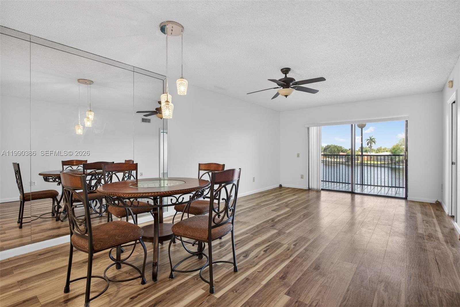 9670 West McNab Road, Unit 208 Tamarac, FL 33321 - Photo 12 of 47 a view of a dining room with furniture window and wooden floor