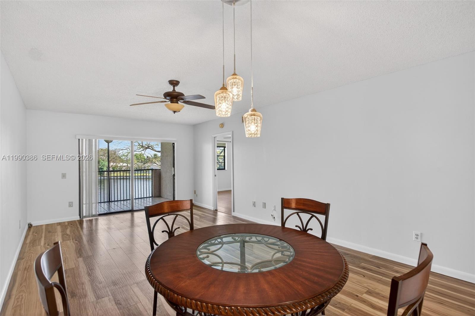 9670 West McNab Road, Unit 208 Tamarac, FL 33321 - Photo 13 of 47 a view of a dining room with furniture wooden floor and chandelier