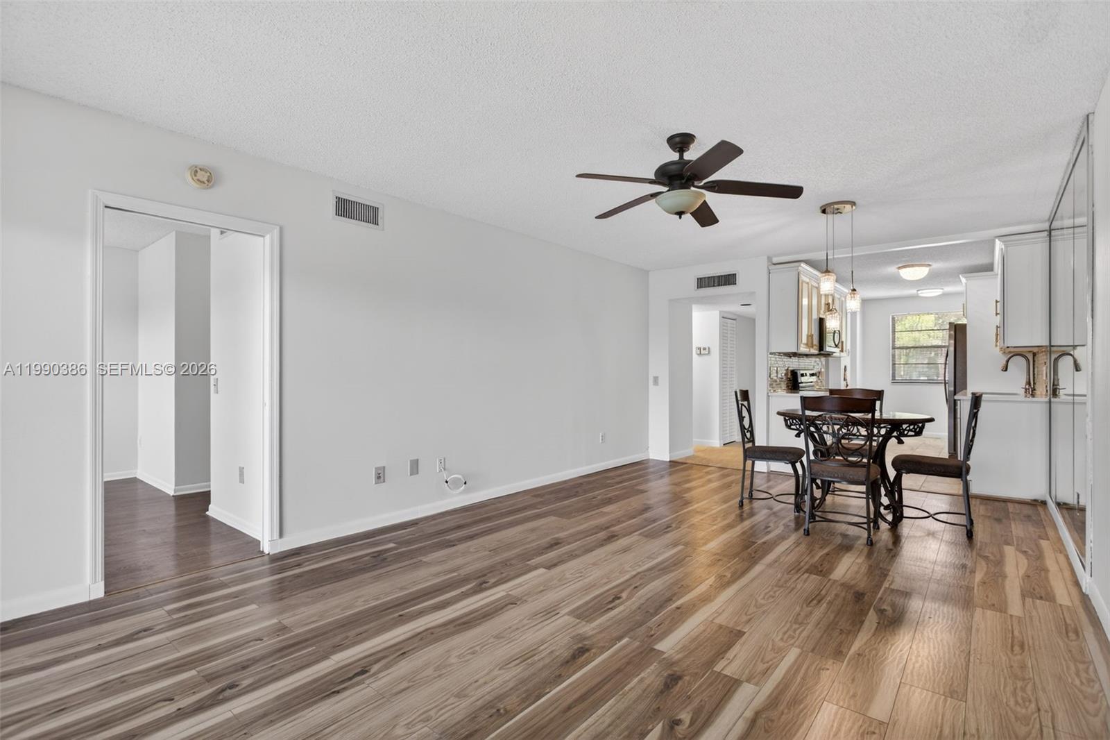 9670 West McNab Road, Unit 208 Tamarac, FL 33321 - Photo 16 of 47 a view of a livingroom with furniture and a table chairs