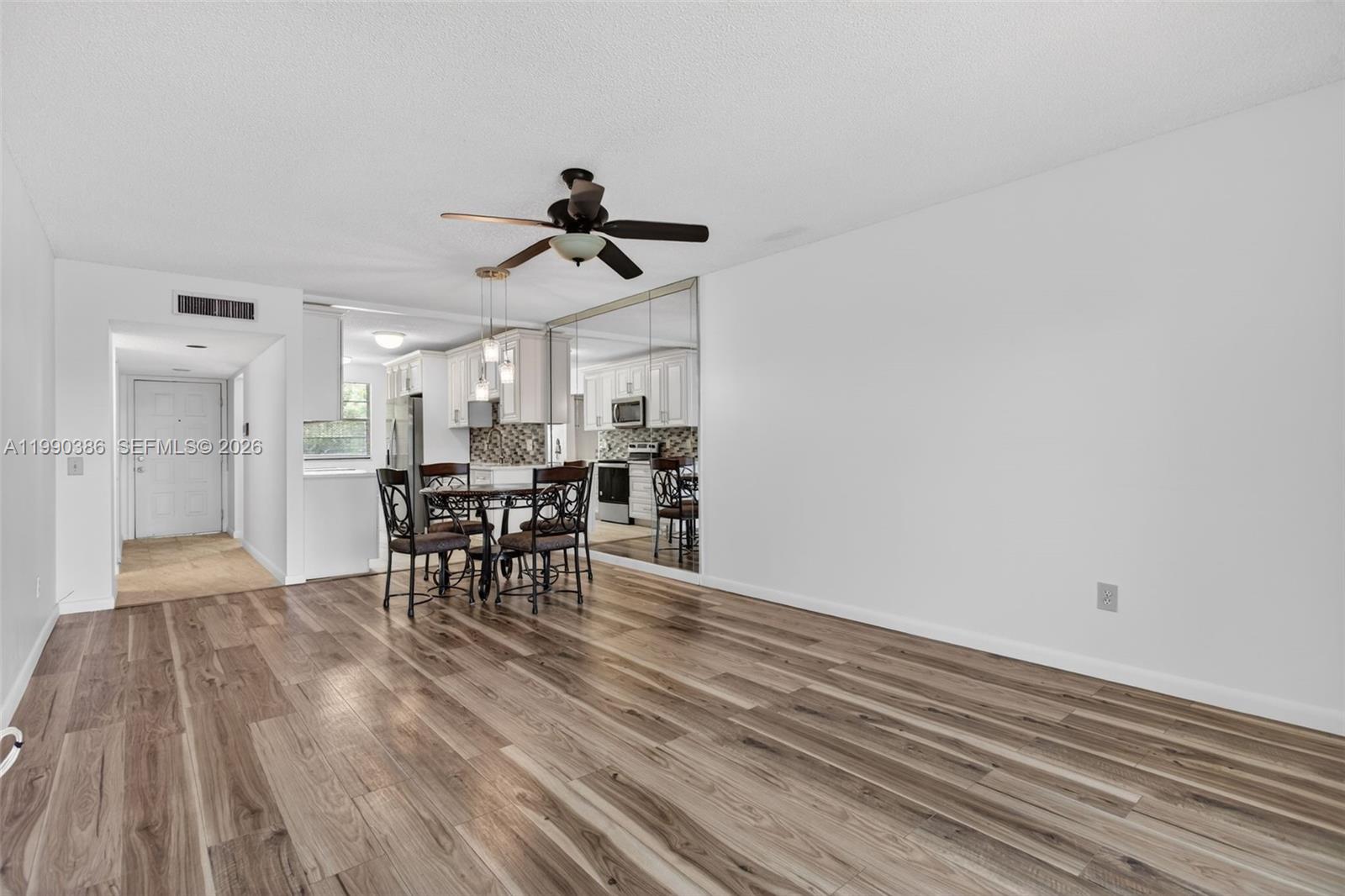 9670 West McNab Road, Unit 208 Tamarac, FL 33321 - Photo 17 of 47 a view of a dining room with furniture and a chandelier