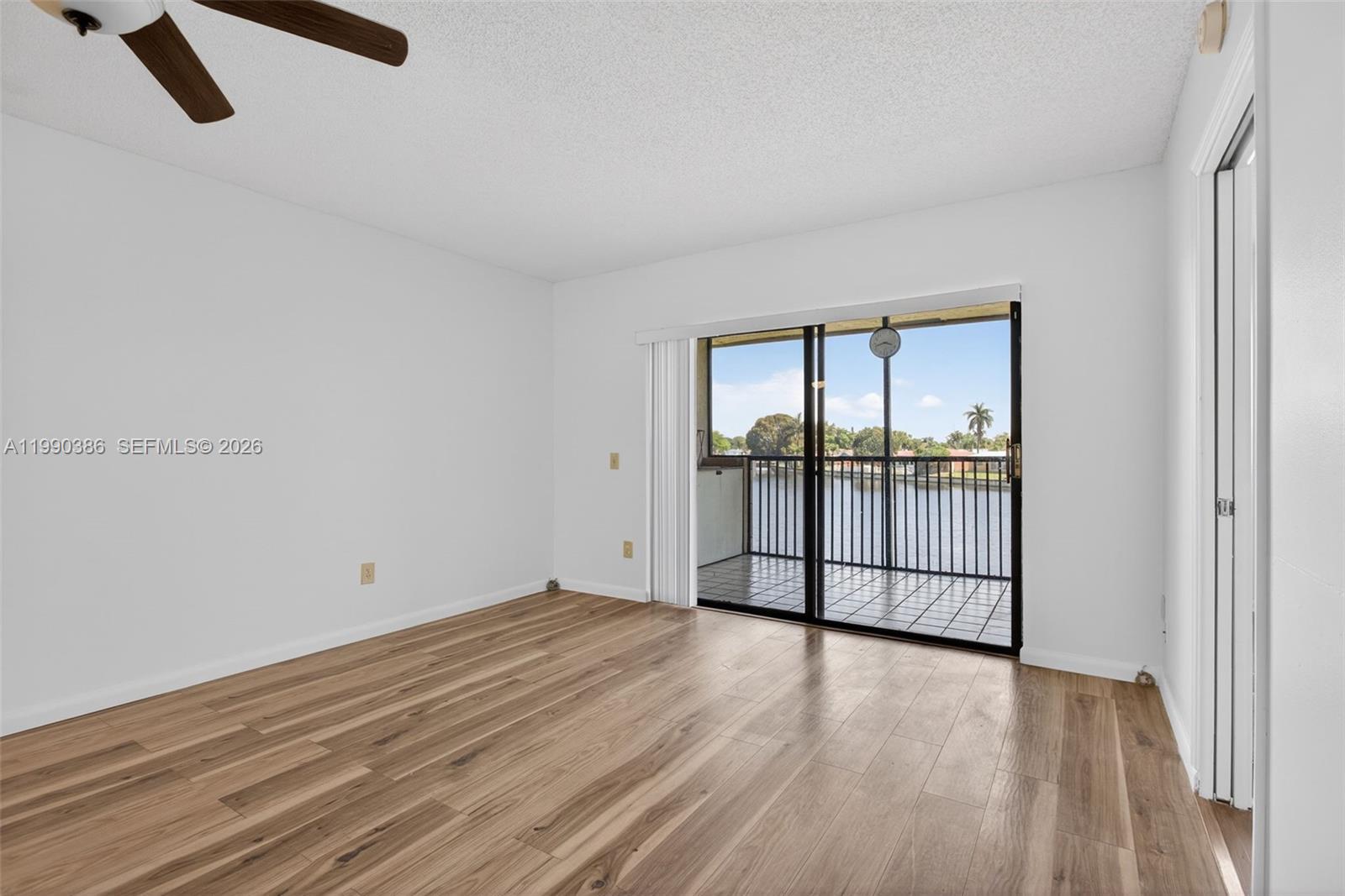 9670 West McNab Road, Unit 208 Tamarac, FL 33321 - Photo 18 of 47 an empty room with wooden floor and windows