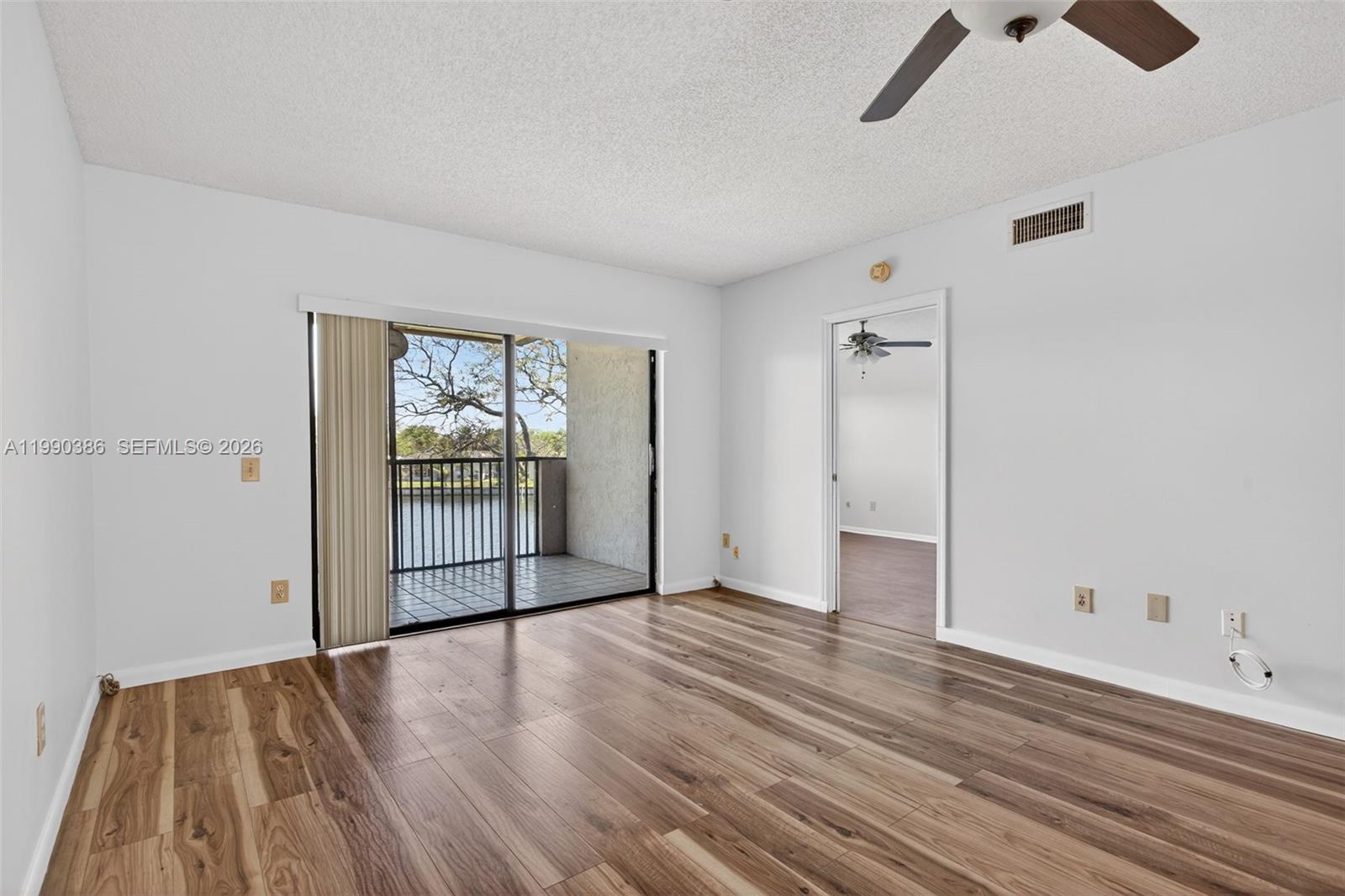 9670 West McNab Road, Unit 208 Tamarac, FL 33321 - Photo 22 of 47 wooden floor in an empty room with a window