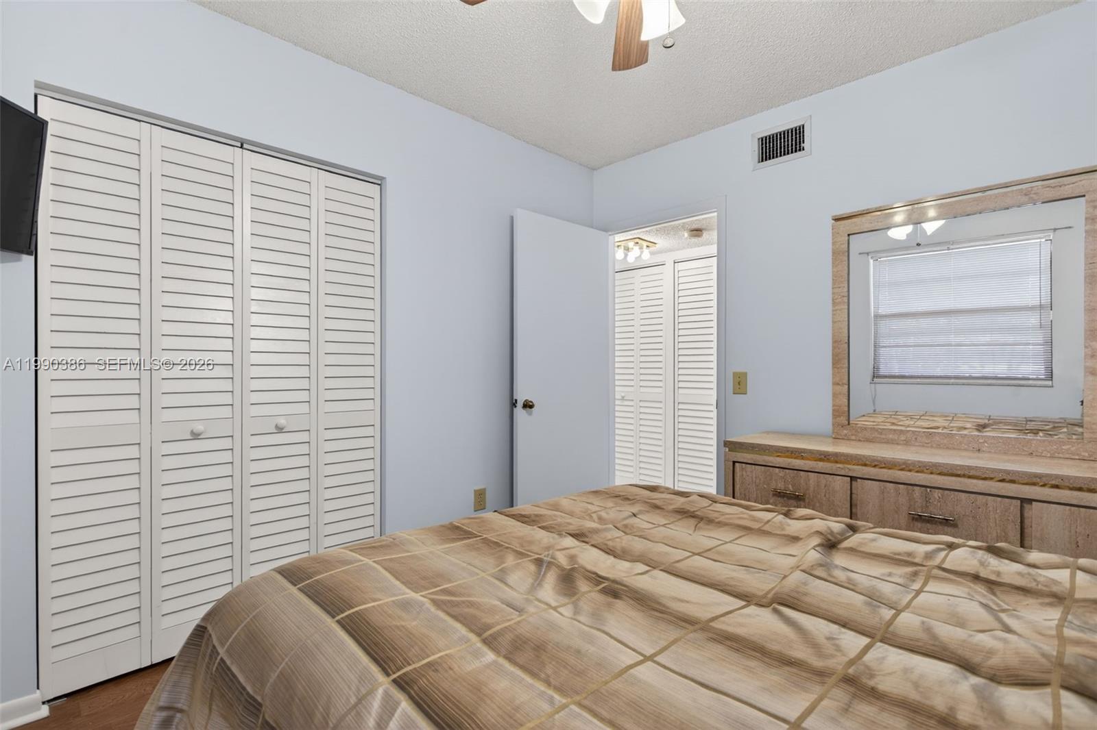 9670 West McNab Road, Unit 208 Tamarac, FL 33321 - Photo 29 of 47 a bedroom with a bed and a window