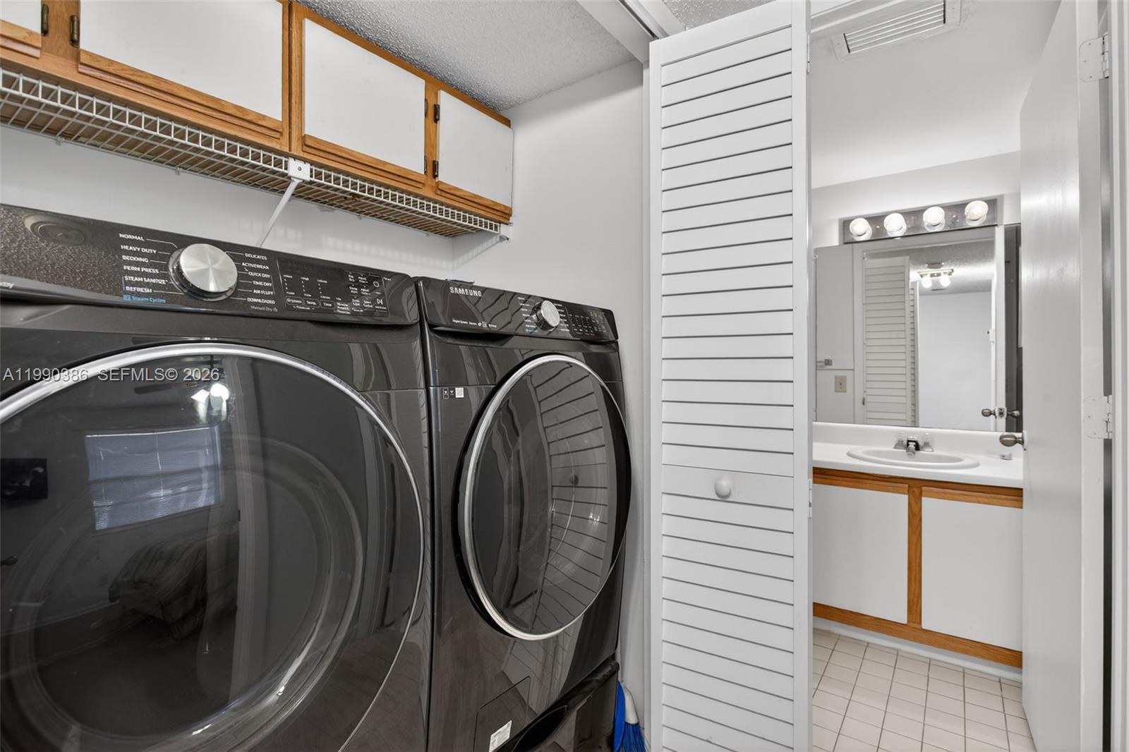 9670 West McNab Road, Unit 208 Tamarac, FL 33321 - Photo 30 of 47 a utility room with a washer and dryer