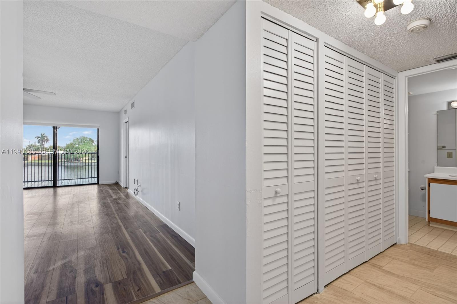 9670 West McNab Road, Unit 208 Tamarac, FL 33321 - Photo 31 of 47 a view of hallway with wooden floor
