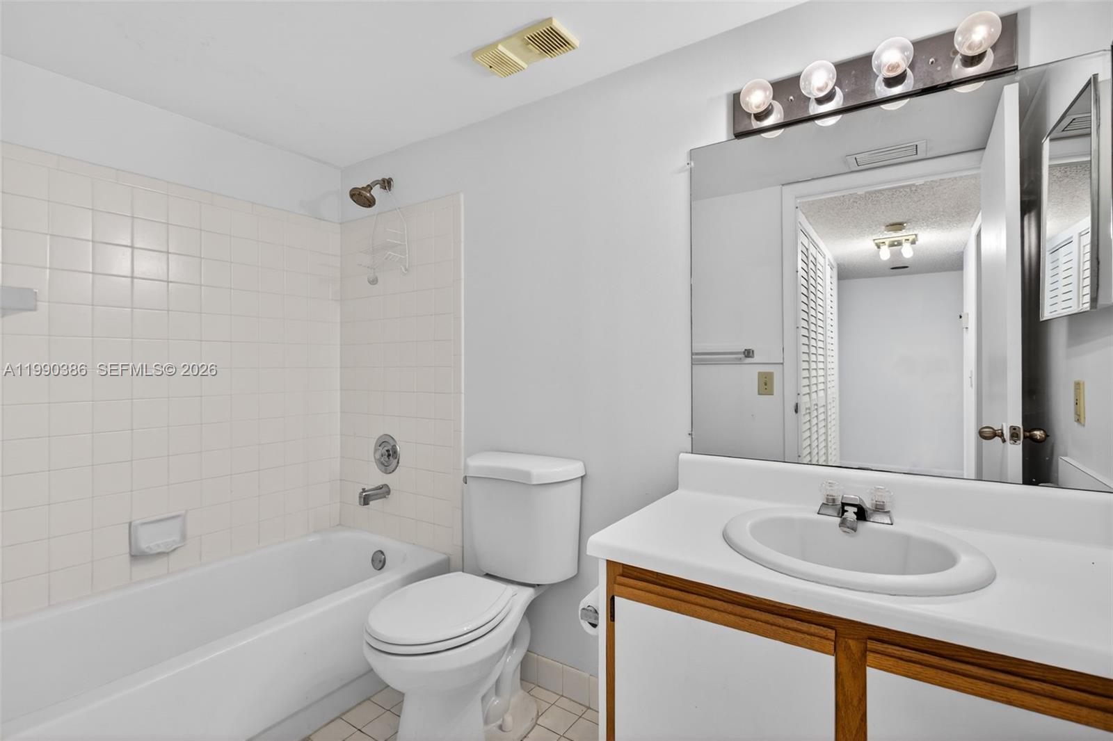 9670 West McNab Road, Unit 208 Tamarac, FL 33321 - Photo 32 of 47 a bathroom with a sink and a mirror