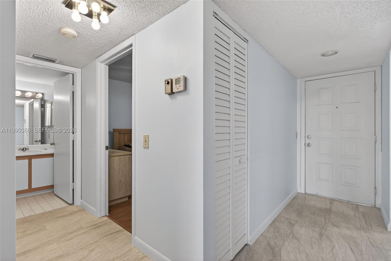 9670 West McNab Road, Unit 208 Tamarac, FL 33321 - Photo 34 of 47 a view of a hallway with bathroom and bathroom