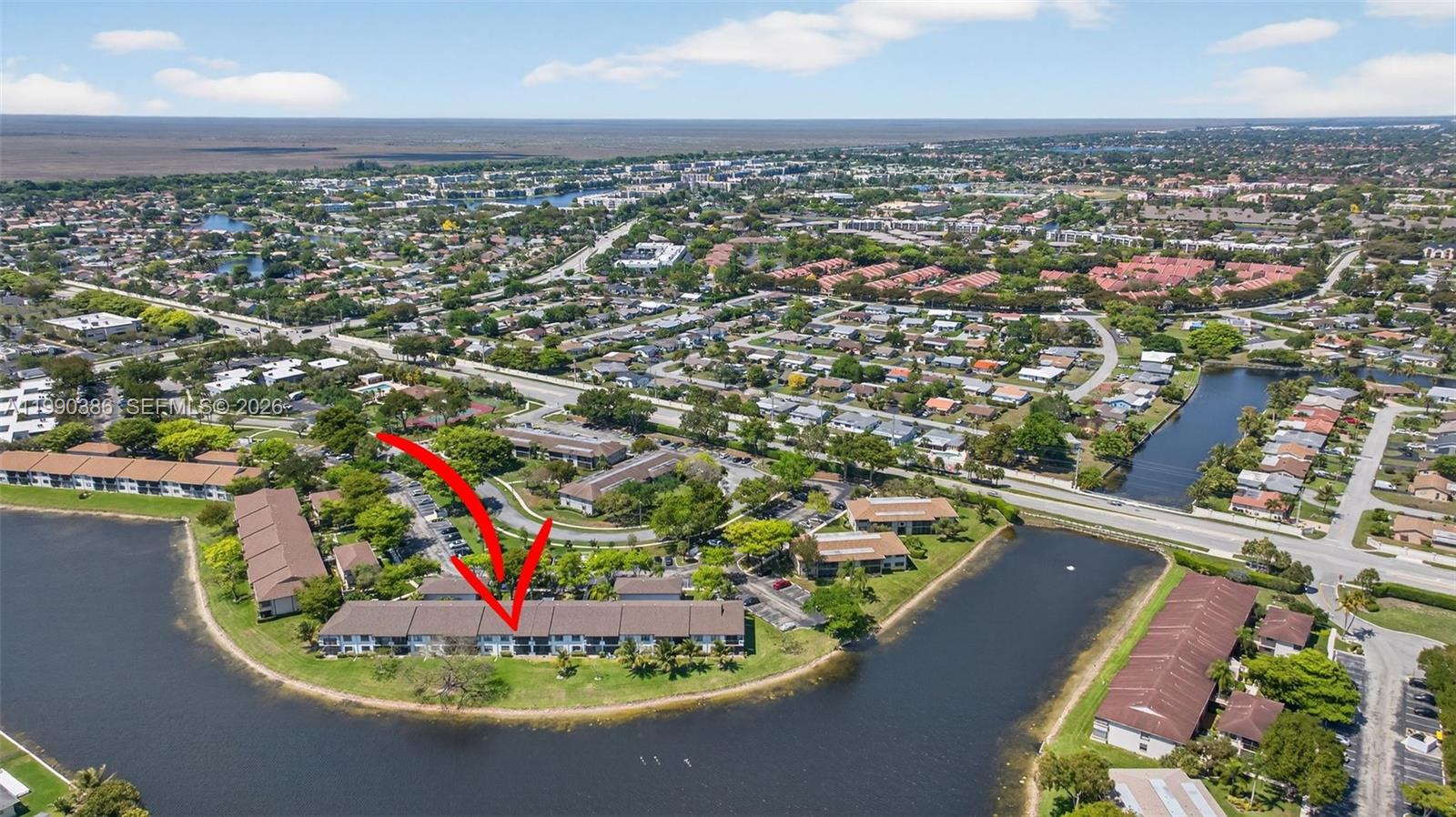9670 West McNab Road, Unit 208 Tamarac, FL 33321 - Photo 40 of 47 an aerial view of a house with a swimming pool outdoor seating and mountain view in back