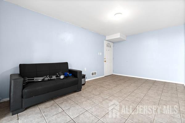 285 Water Street Perth Amboy, NJ 08861 - Photo 13 of 16 a living room with furniture and a flat screen tv