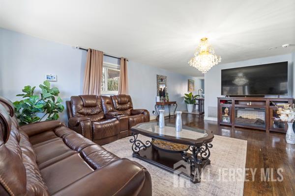 285 Water Street Perth Amboy, NJ 08861 - Photo 3 of 16 a living room with furniture and a flat screen tv