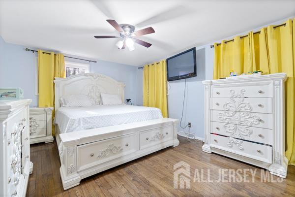 285 Water Street Perth Amboy, NJ 08861 - Photo 7 of 16 a bedroom with a bed dresser and a window