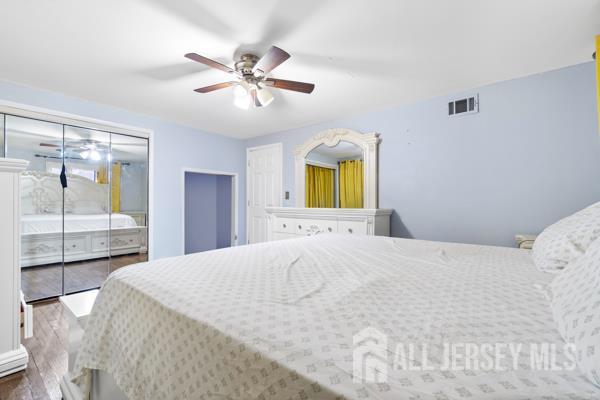 285 Water Street Perth Amboy, NJ 08861 - Photo 8 of 16 a bedroom with a bed and a chandelier