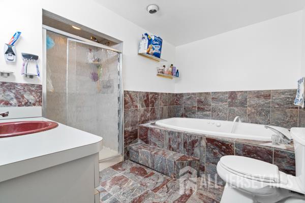 285 Water Street Perth Amboy, NJ 08861 - Photo 9 of 16 a bathroom with a sink toilet and shower