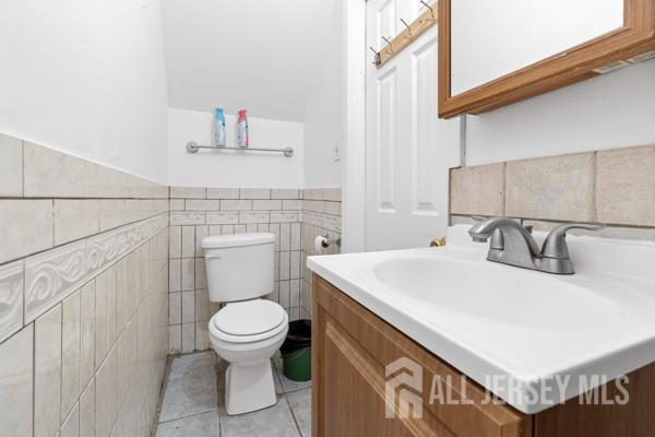 285 Water Street Perth Amboy, NJ 08861 - Photo 10 of 16 a bathroom with a sink a toilet and a mirror