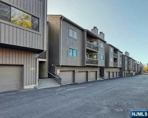 a view of a house with a wooden fence