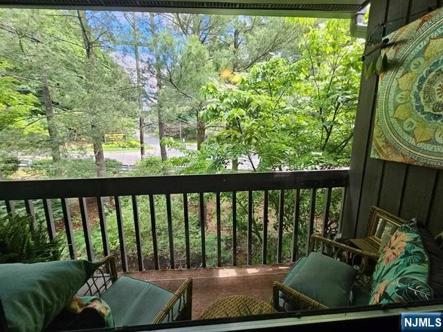 a view of balcony with furniture and garden