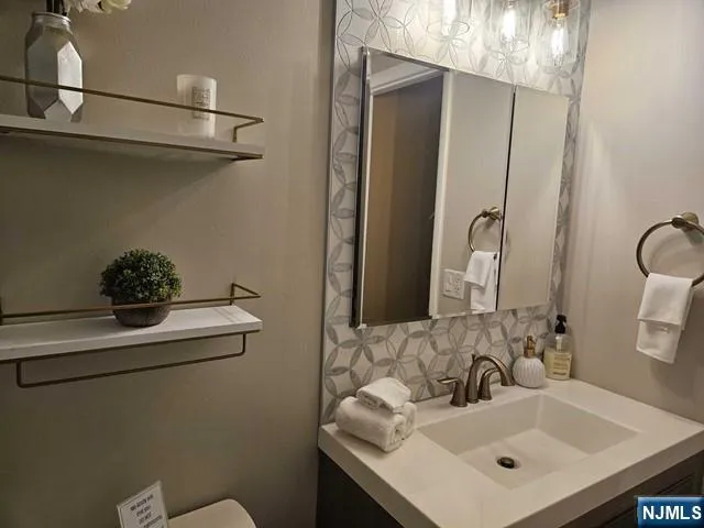 a bathroom with a sink and a mirror