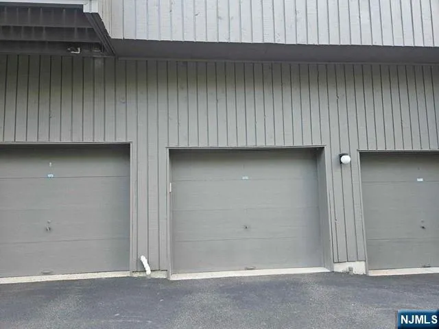 a view of an empty room with wooden wall