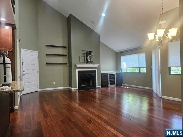 a view of a room with wooden floor and a fireplace