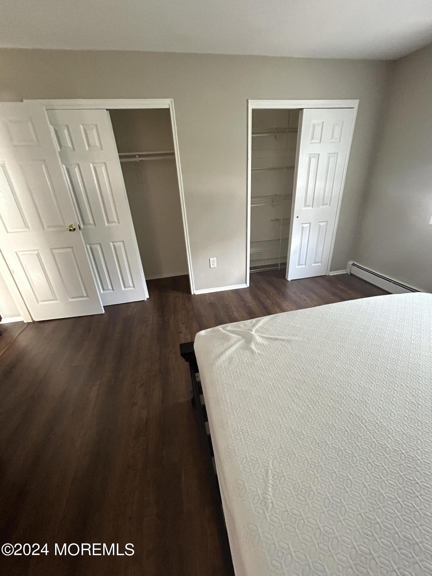 12 Manchester Court, Unit C Freehold, NJ 07728 - Photo 15 of 16 a bedroom with a bed and wooden floor