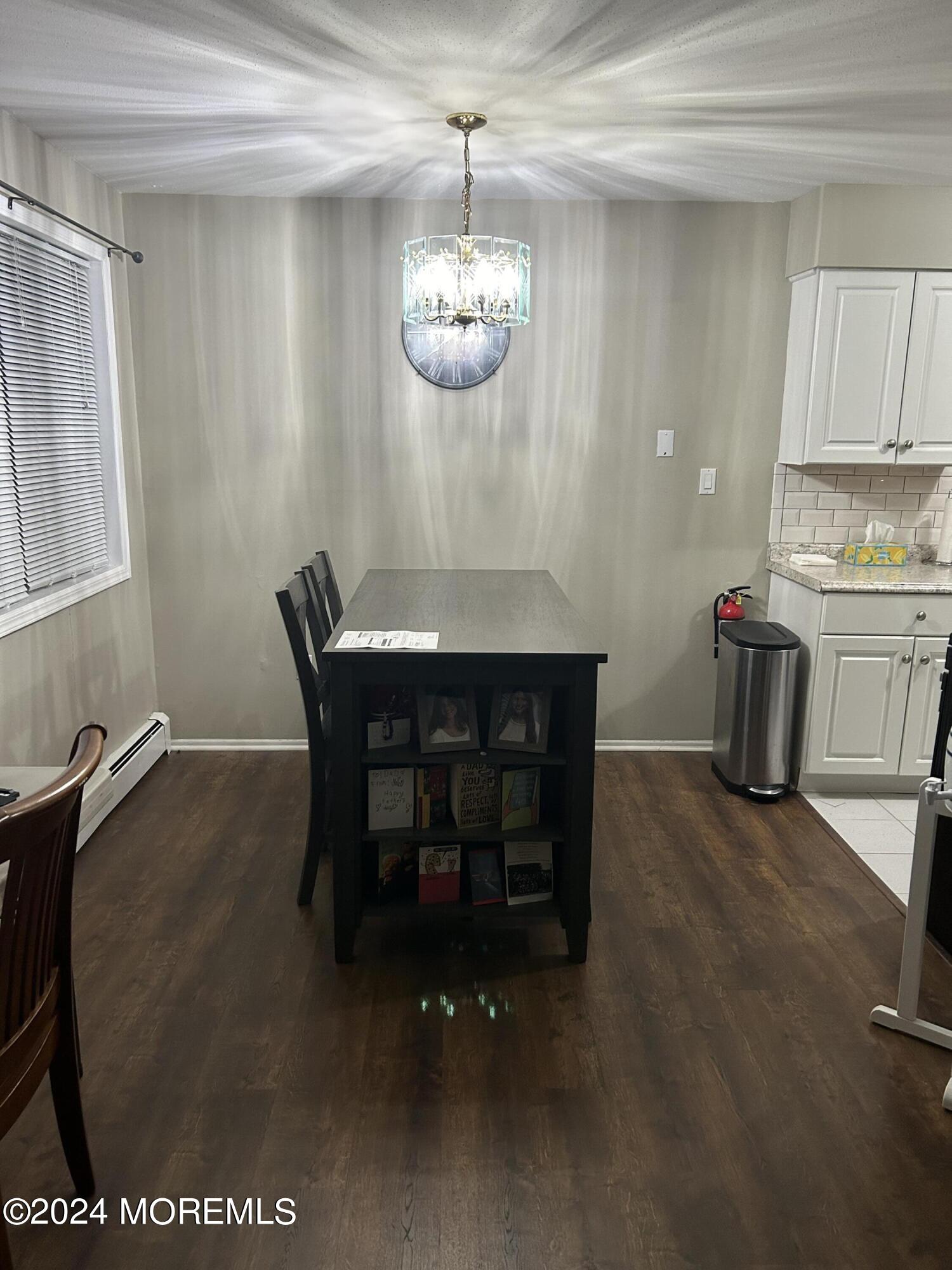 12 Manchester Court, Unit C Freehold, NJ 07728 - Photo 3 of 16 a dining room with a table and chairs