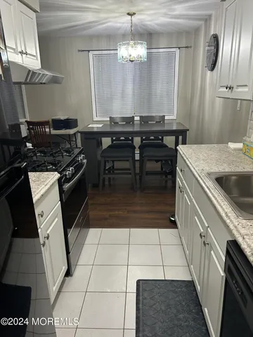 a kitchen with a sink and a stove top oven