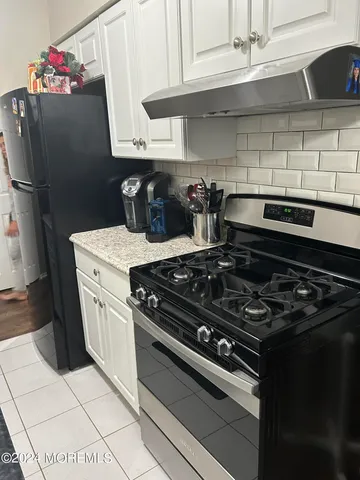 a white stove top oven sitting inside of a kitchen