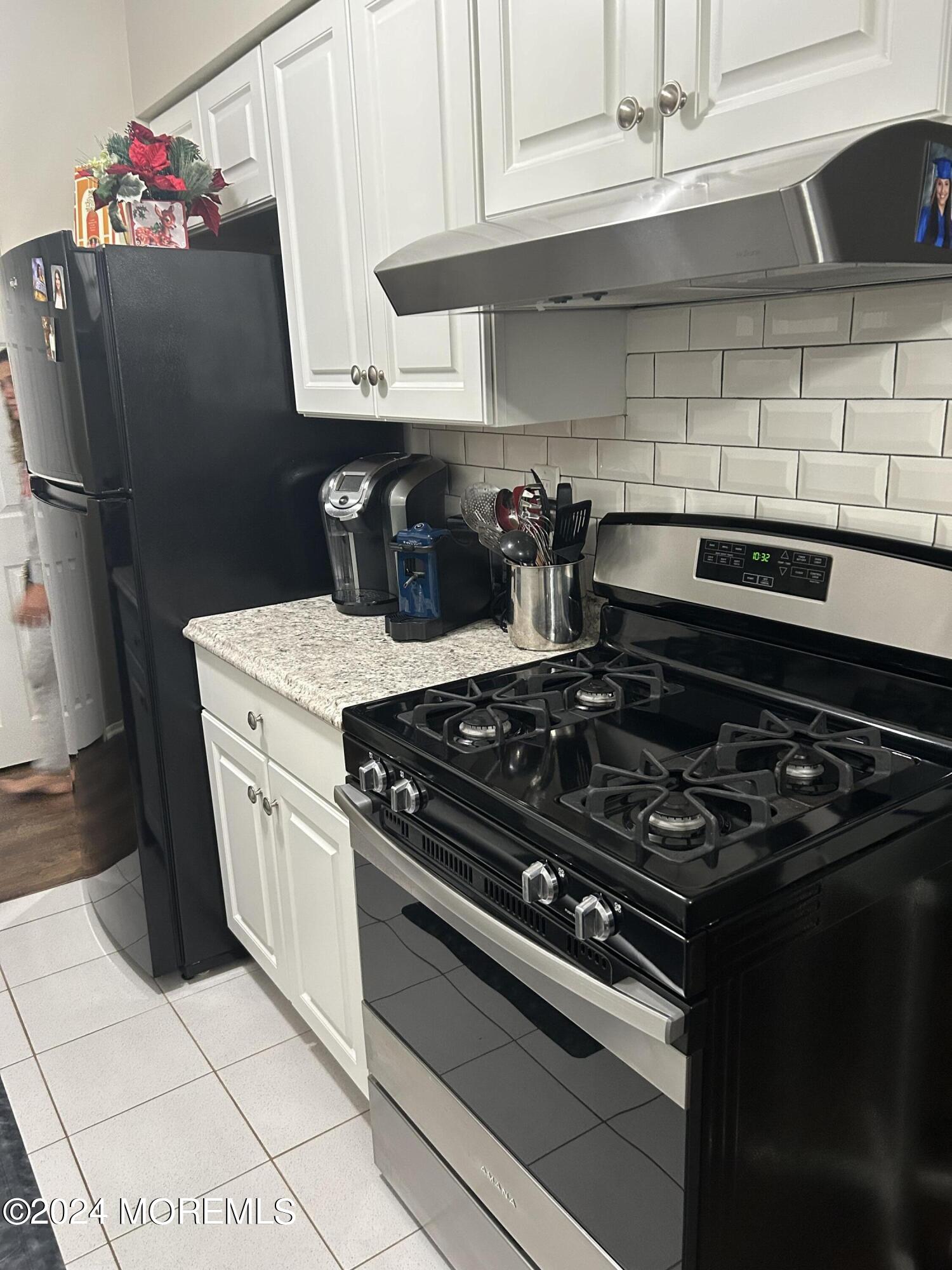 12 Manchester Court, Unit C Freehold, NJ 07728 - Photo 8 of 16 a white stove top oven sitting inside of a kitchen