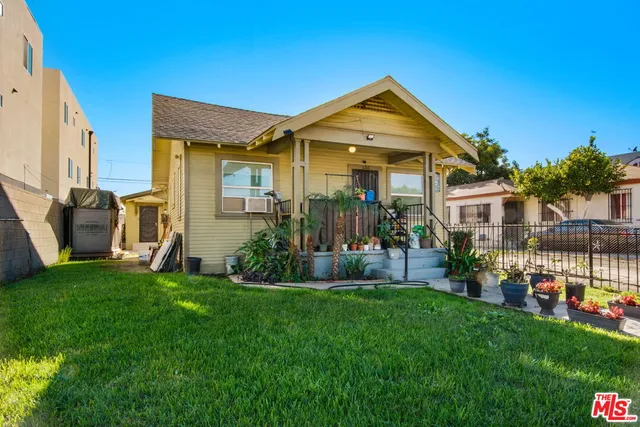 a front view of a house with a yard and porch