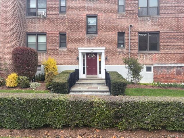 14 South Broadway, Unit 102B Irvington, NY 10533 - Photo 2 of 16 a front view of a house with garden