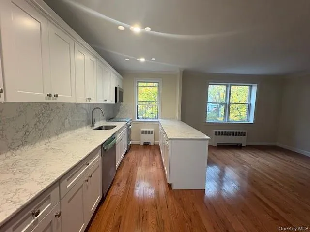 a view of kitchen with wooden floor and electronic appliances