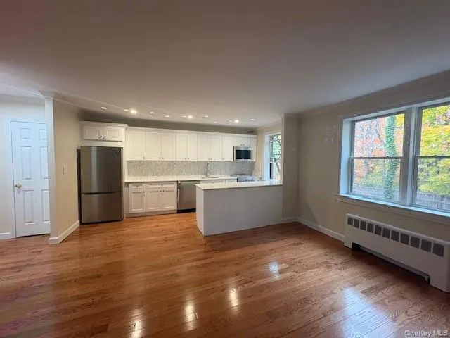 a kitchen with stainless steel appliances granite countertop a sink and cabinets