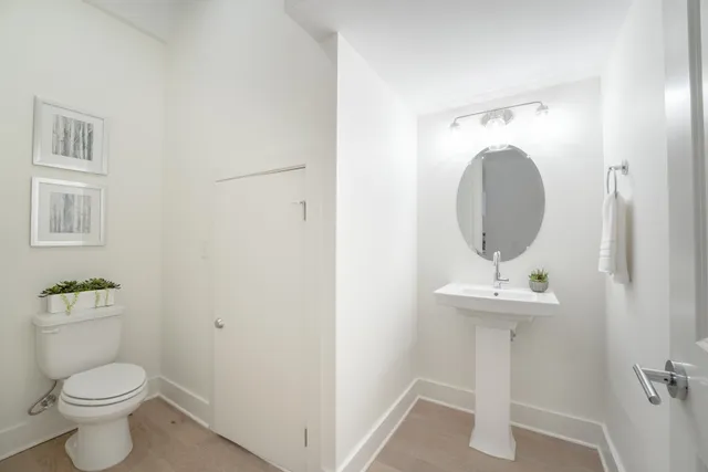 a bathroom with a toilet sink and mirror