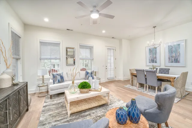 a living room with furniture and a chandelier