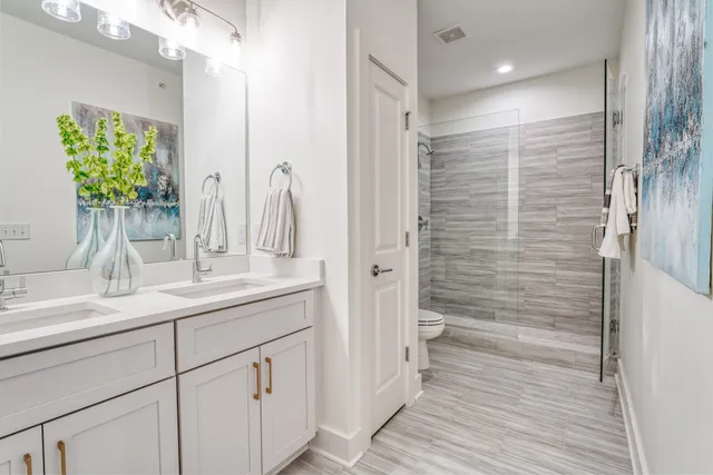 a bathroom with a shower sink and mirror
