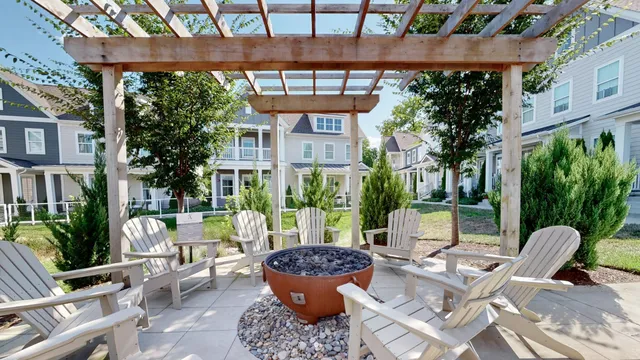 a view of a patio with couches and table and chairs under an umbrella
