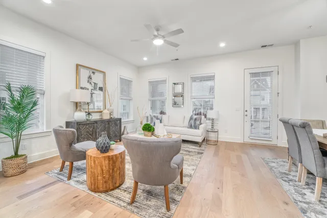 a living room with furniture and a potted plant
