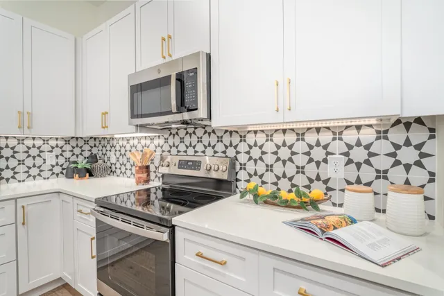 a kitchen with a stove a sink and a microwave