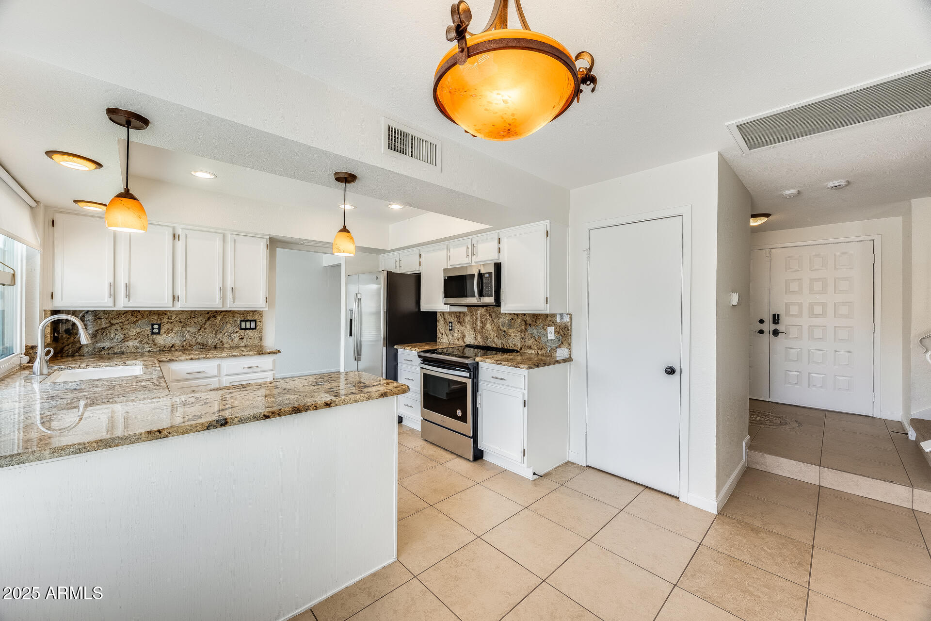 1929 East Redfield Road Phoenix, AZ 85022 - Photo 18 of 58 a large kitchen with cabinets and stainless steel appliances