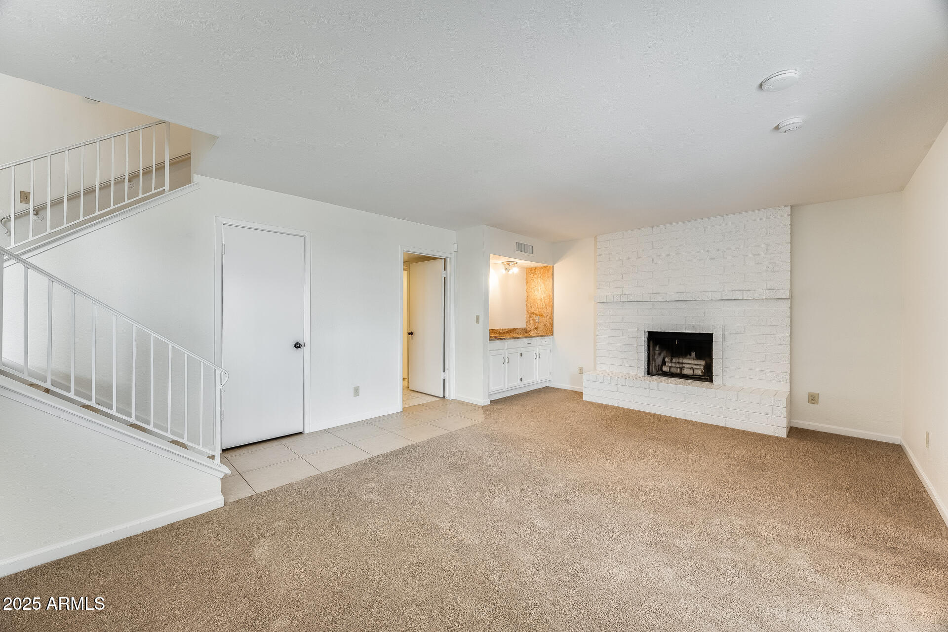 1929 East Redfield Road Phoenix, AZ 85022 - Photo 21 of 58 a view of an empty room with a fireplace and a window