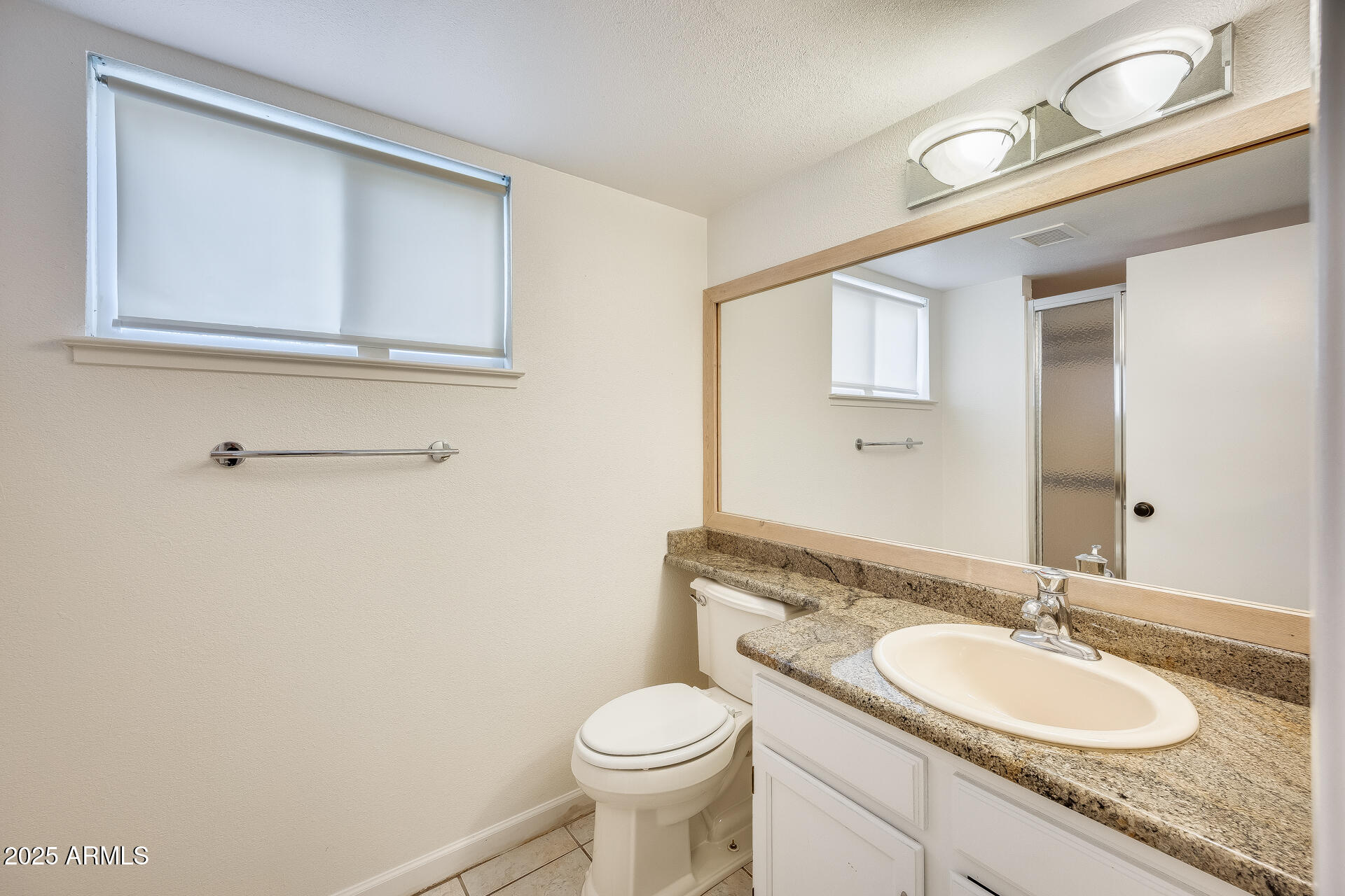 1929 East Redfield Road Phoenix, AZ 85022 - Photo 24 of 58 a bathroom with a granite countertop toilet sink and mirror