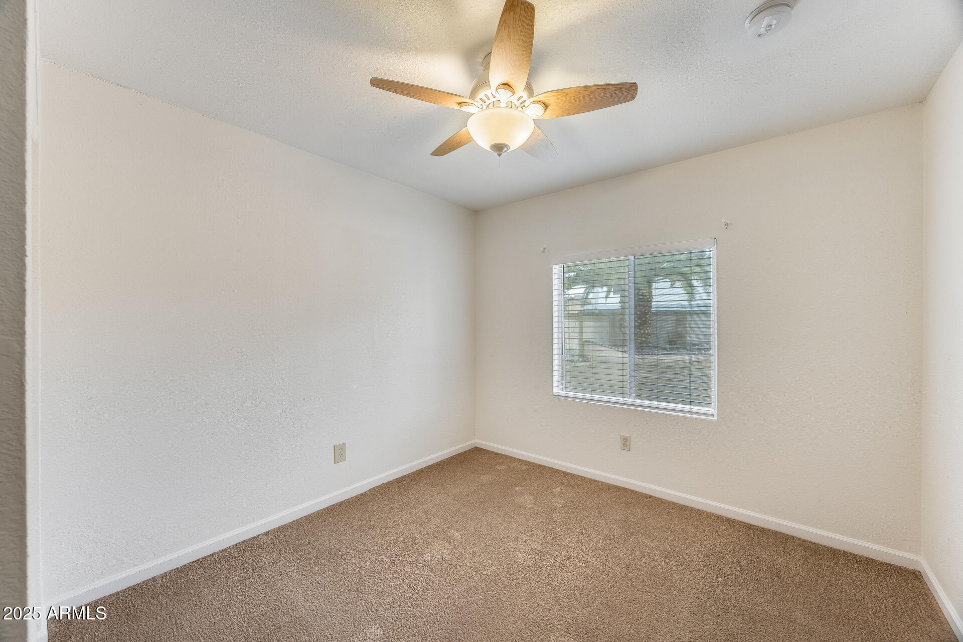 1929 East Redfield Road Phoenix, AZ 85022 - Photo 26 of 58 an empty room with a window and a fan