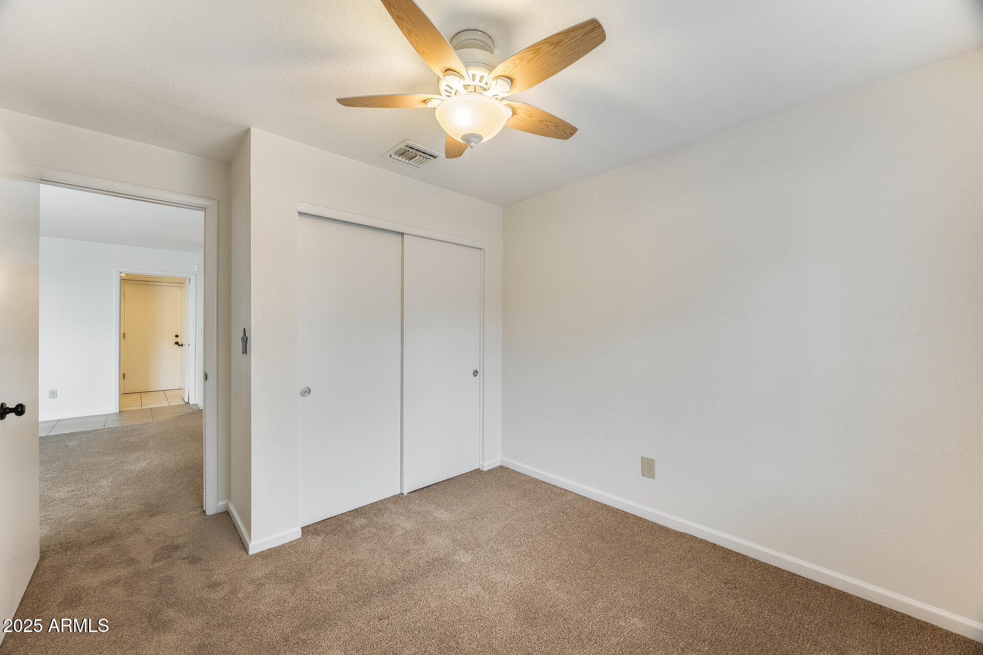 1929 East Redfield Road Phoenix, AZ 85022 - Photo 27 of 58 an empty room with closet and a chandelier fan