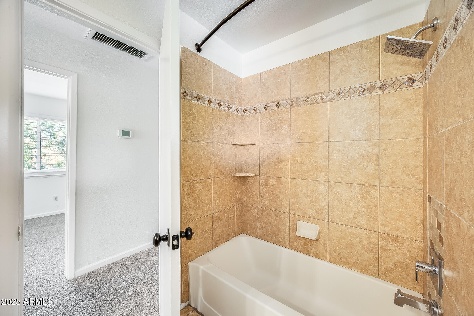 1929 East Redfield Road Phoenix, AZ 85022 - Photo 38 of 58 a bathroom with a bathtub and shower