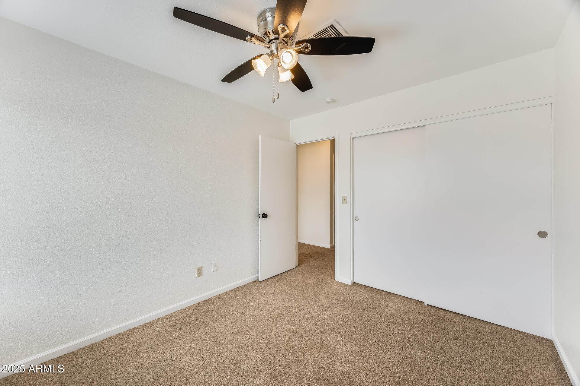 1929 East Redfield Road Phoenix, AZ 85022 - Photo 42 of 58 an empty room with a ceiling fan and a window