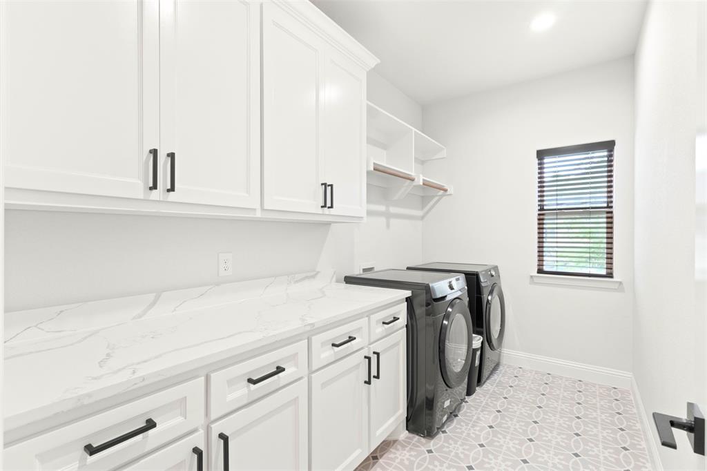 105 Clayton Crossing Springtown, TX 76082 - Photo 25 of 40 a utility room with cabinets washer and dryer