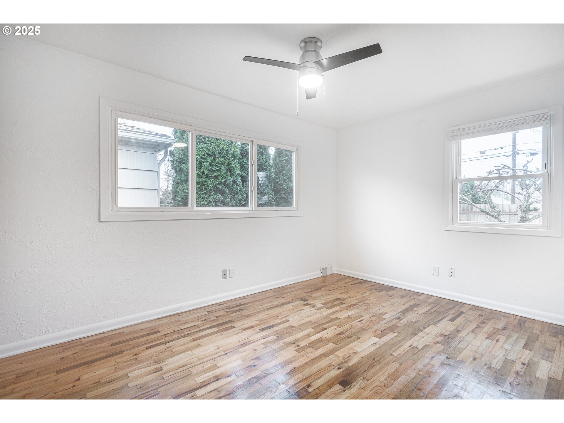 1155 18th Street Northeast Salem, OR 97301 - Photo 24 of 40 an empty room with wooden floor chandelier and windows