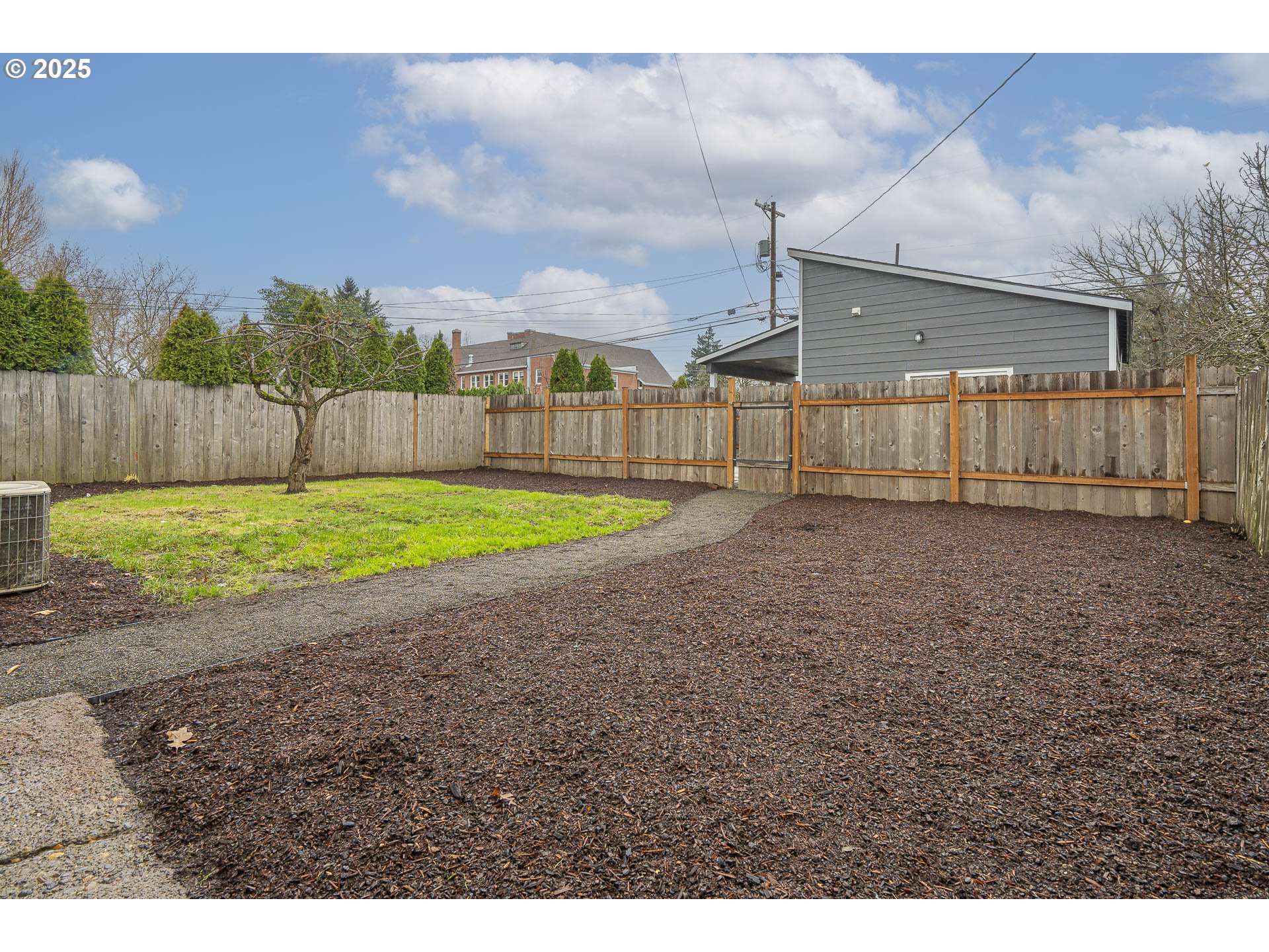 1155 18th Street Northeast Salem, OR 97301 - Photo 32 of 40 a view of a backyard with a barbeque and wooden fence