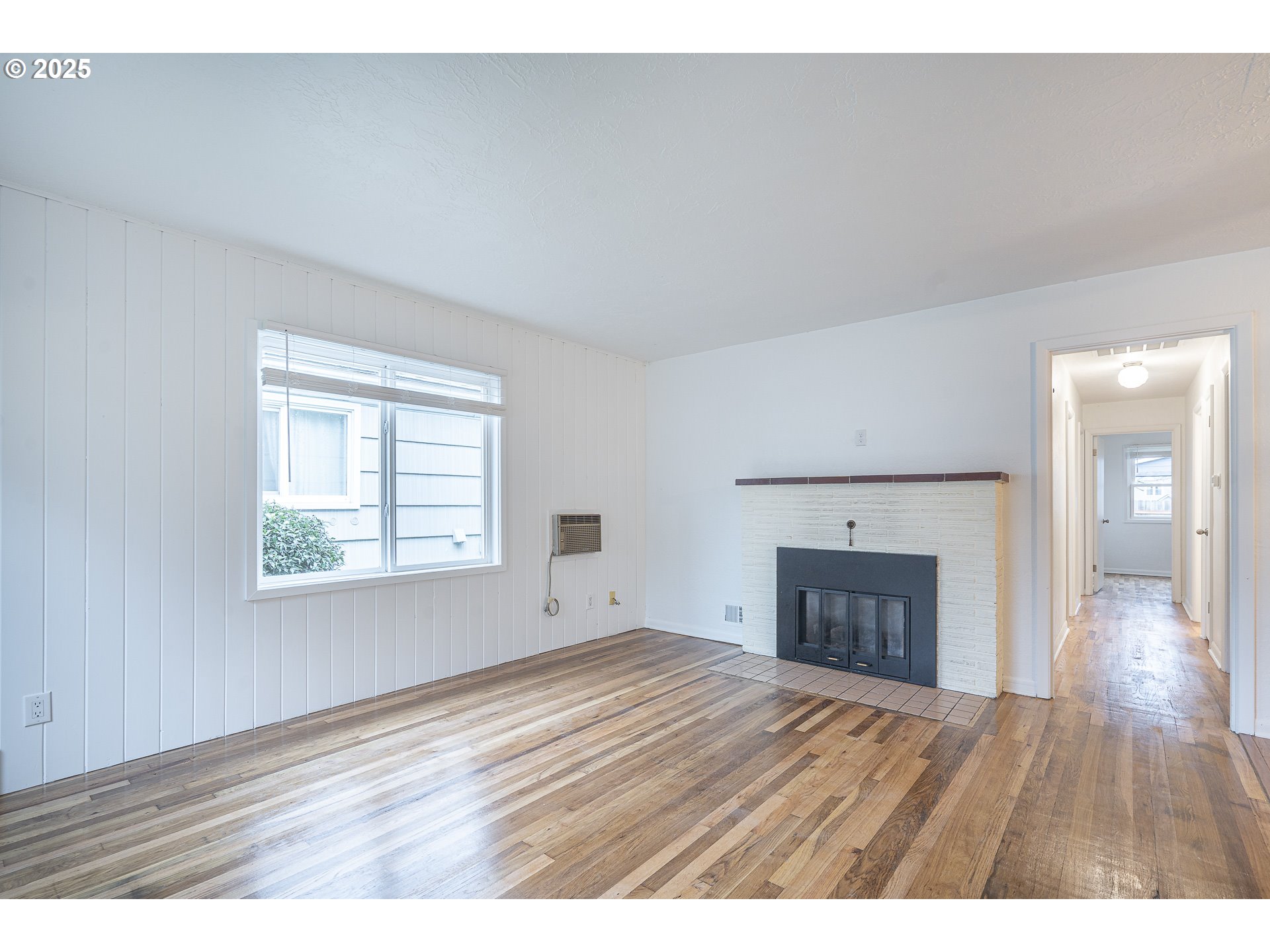 1155 18th Street Northeast Salem, OR 97301 - Photo 6 of 40 a view of an empty room with a fireplace and a window